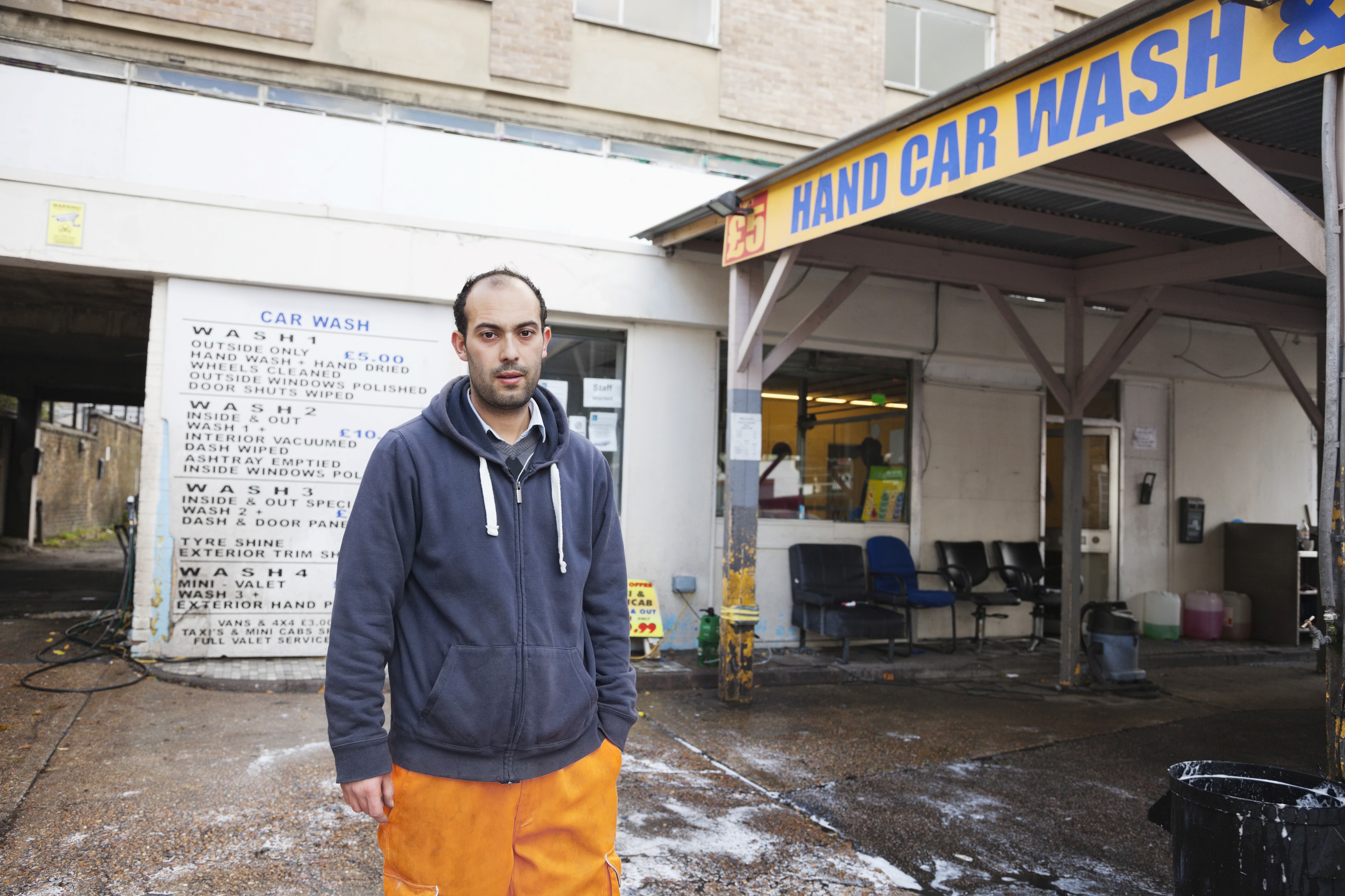 Man Standing in Front of a Car Wash